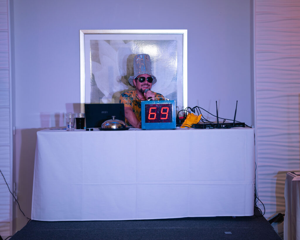 Bingo caller smiling with a sparkly hat on at the Marsham Court Hotel Bournemouth